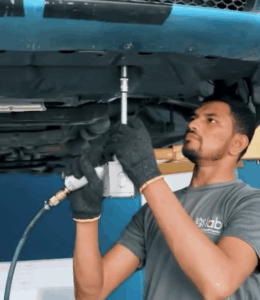 Certified technician inspecting the engine of a Dodge Charger