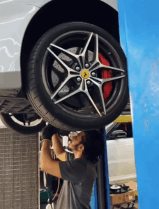Skilled mechanic performing maintenance on Ferrari California T