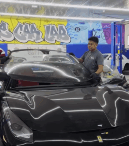 Skilled technician performing Ferrari 488 GTB windscreen replacement