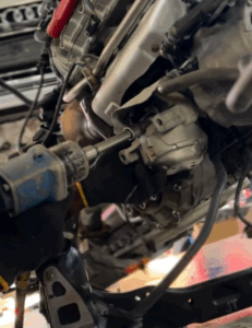 Skilled technician performing engine replacement on Audi A6