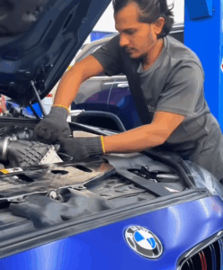 Skilled technician performing major service on a BMW M6 in Dubai