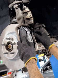 Technician performing a Benz G63 brake pad replacement service