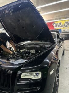 Front view of Rolls-Royce Ghost with hood open during fuel injector replacement service.
