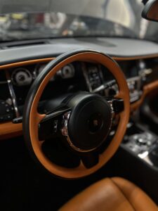 Luxury interior steering wheel of Rolls-Royce Ghost after fuel injector replacement service.