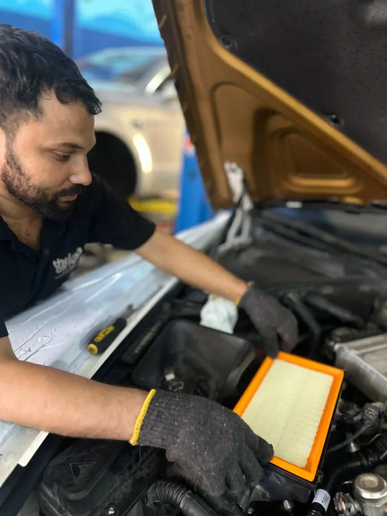 Technician replacing the air filter during Rolls Royce Phantom minor service in Dubai.